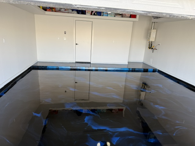 Blue and silver metallic epoxy floor inside a finished residential garage